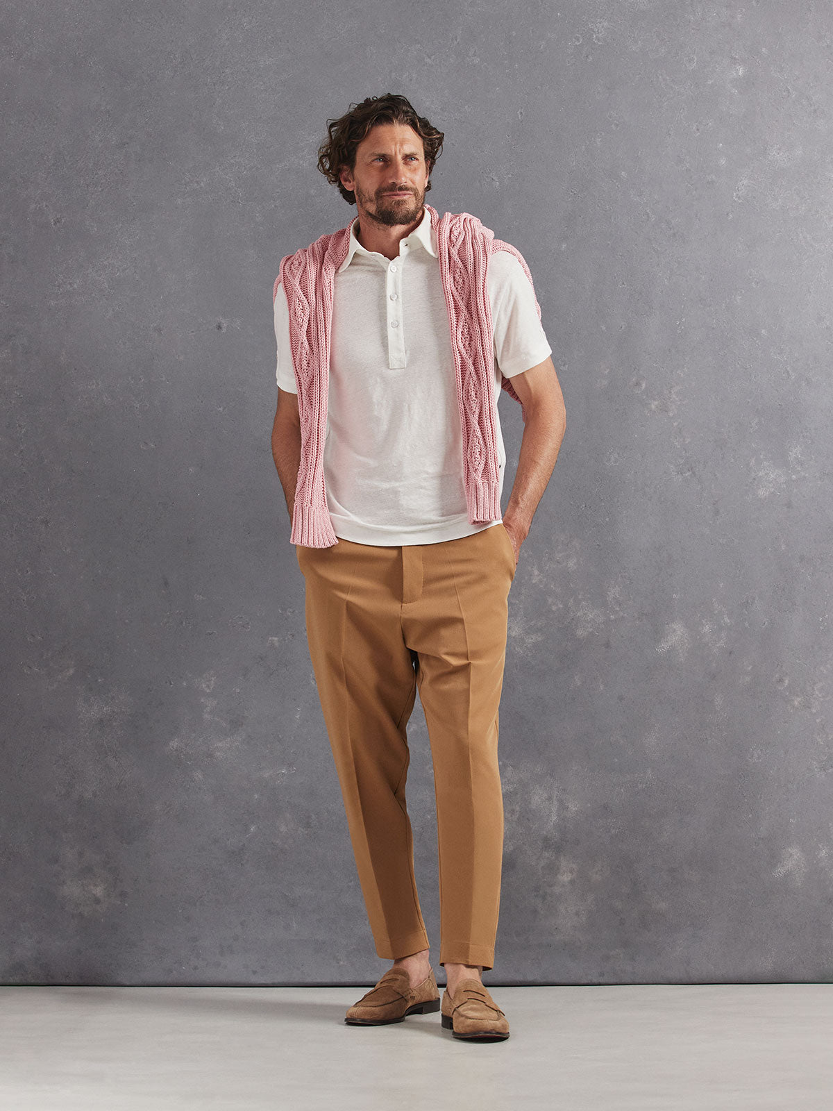 Madeira French Linen Short Sleeve Polo in *White Lotus* (off-white) styled with Dark Soybean Retinol Pant and Quartz Pink Power Cable Sweater 2023 Edition on shoulders — full length lookbook | Y.Chroma