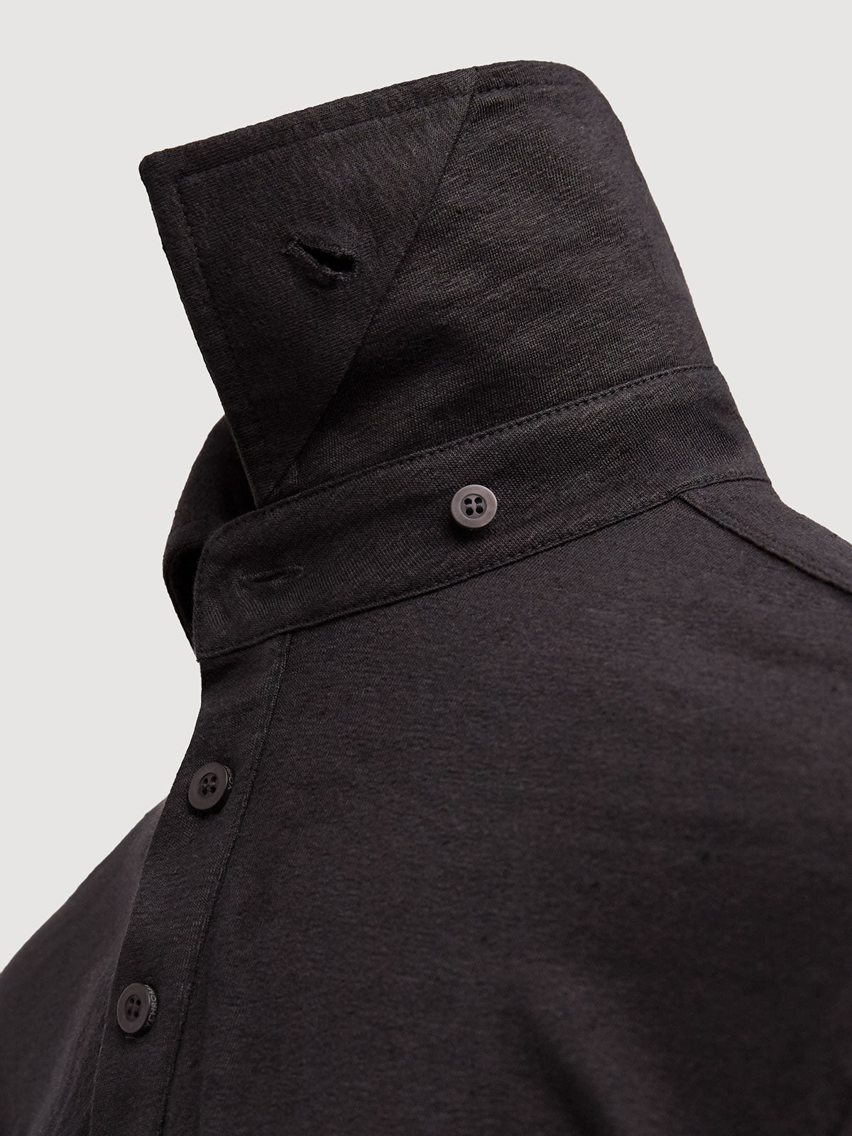 Madeira French Linen Long Sleeve Polo in *Berlin Black* (black) — collar button system detail | Y.Chroma